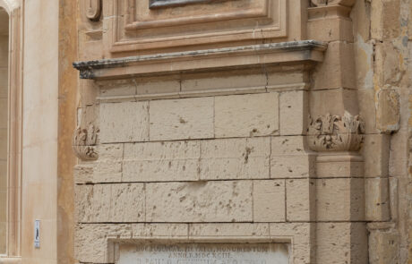 Religious wall shrine painting on a limestone building in Mdina