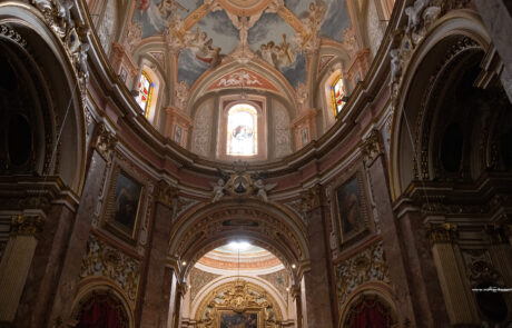 Ornately frescoed baroque church interior ceiling in Mdina, Malta