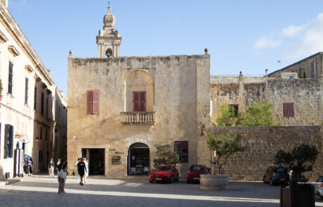 Historic stone square with fortified buildings in Mdina, Malta