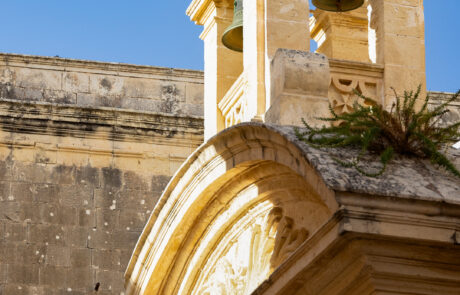 Baroque church facade with a bell tower in Mdina, Malta