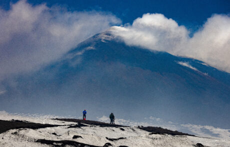 Mount Etnas snow-covered summit seen through clouds