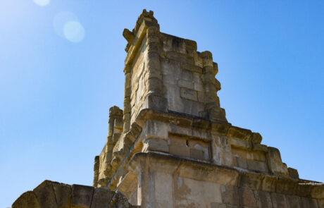 Ancient stone ruin wall against a blue sky at Tindari, Sicily