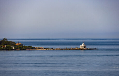 Distant view of a lighthouse on a small peninsula at Kefalonia