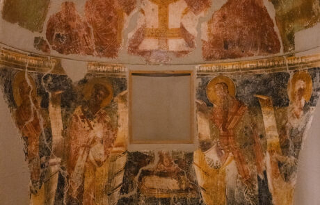 Interior of a monastery chapel with faded Byzantine frescoes at Kefalonia
