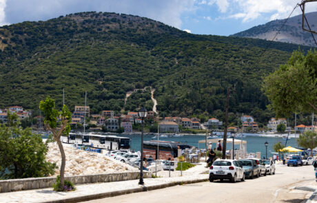 Hillside view over a harbor town with boats and cars at Kefalonia
