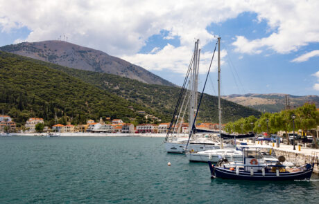 Sailboats moored in a harbor with mountains in the background at Kefalonia