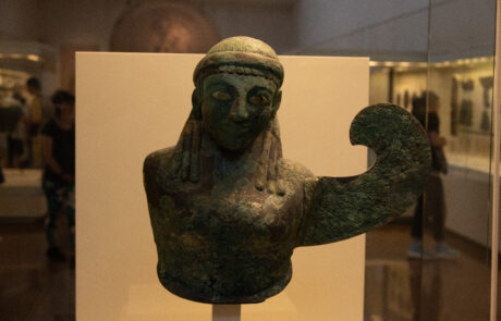 Bronze figurine of a womans head and arm at the Olympia Archaeological Museum