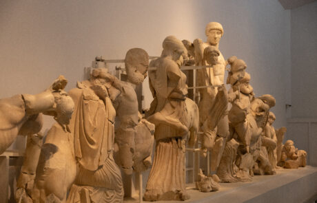 Row of ancient marble statues and pediment figures at the Olympia Archaeological Museum