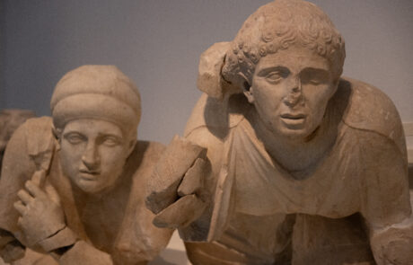 Ancient marble sculpture of two figures at the Olympia Archaeological Museum