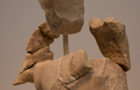 Marble pediment sculpture of a seated bearded man at the Olympia Archaeological Museum