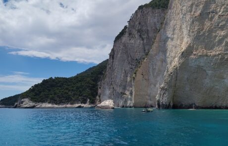 White limestone cliffs meeting turquoise sea along the Zakynthos coastline