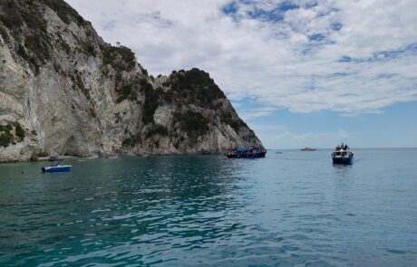 Rocky islets and small boats on turquoise water off the Zakynthos coast