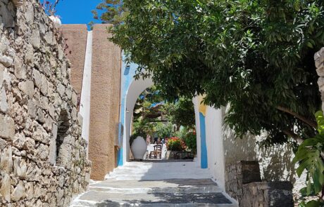 Narrow whitewashed stone staircase between houses at Arolithos village