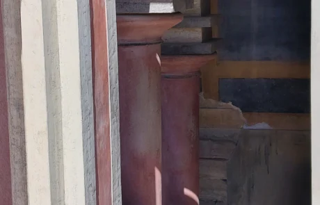 Restored red wooden column and doorway detail at the Palace of Knossos