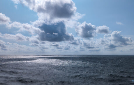 View from the cruise ship deck of the open ocean under dramatic clouds