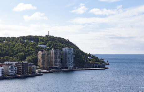 Aerial view of a green hill peninsula with waterfront apartment buildings, Kristiansand, Norway
