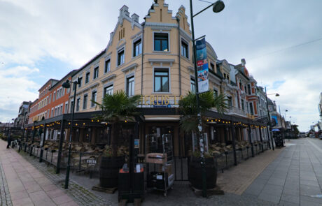 Historic yellow building on a street corner, Kristiansand