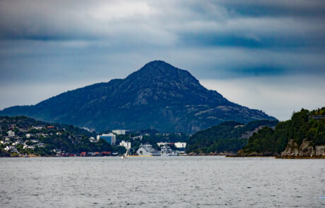 Mountain peak across the water under an overcast sky