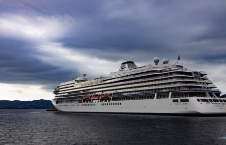 Large white cruise ship on the fjord under a cloudy sky, Bergen, Norway