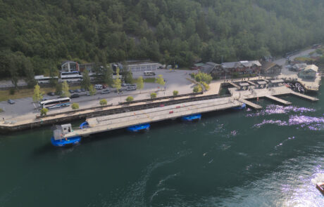 Cruise ship dock area with buildings and buses, Geiranger, Norway
