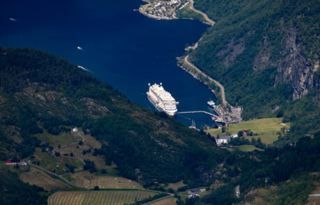 Aerial view of the Geirangerfjord with a cruise ship and terraced farmland, Norway