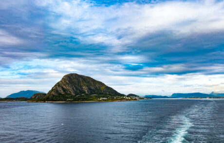 Distinctive pyramid-shaped mountain peak on an island in the fjord