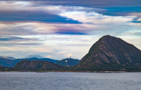 Distinctive pyramid-shaped mountain peak on an island in the fjord, Alesund, Norway