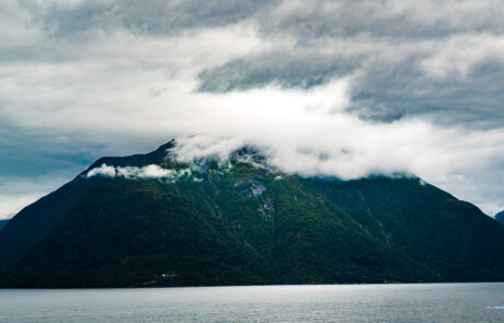 Cloud-covered island rising from a fjord, Flam, Norway
