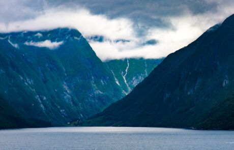 Fjord valley with steep mountains and patches of snow, Flam, Norway