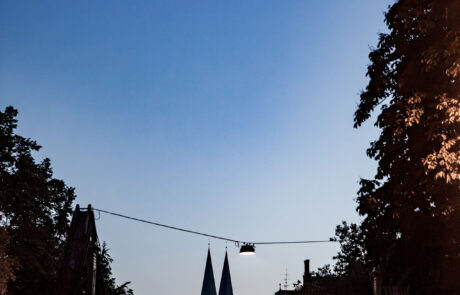 Night view down Muehlenbruecke bridge toward Luebecks illuminated church spires